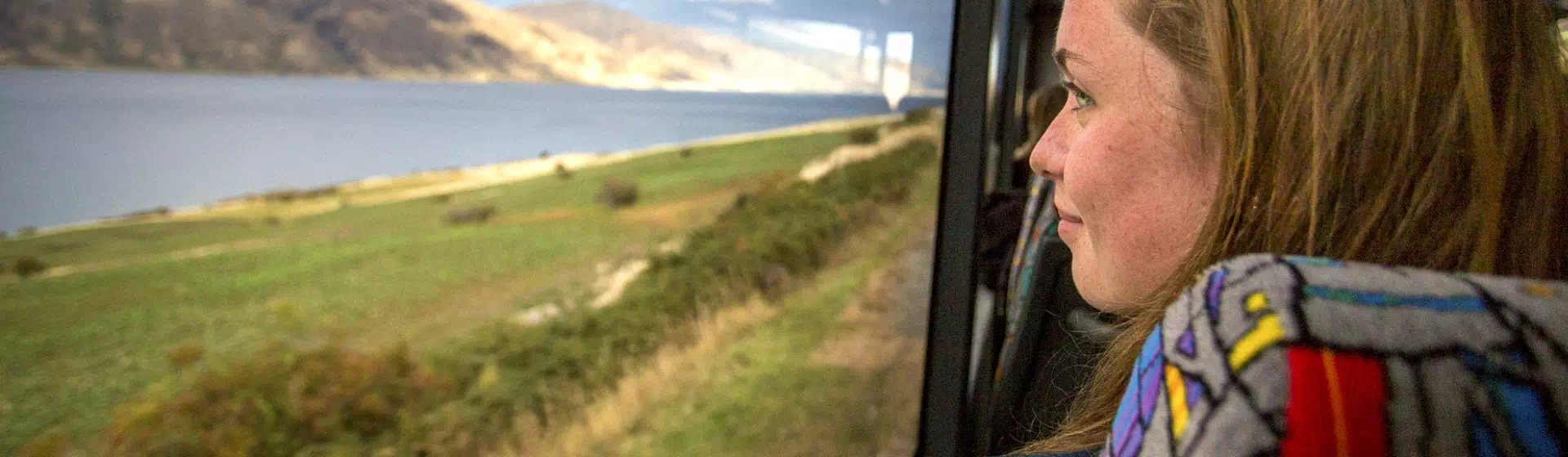 kobieta patrząca przez okno autokaru